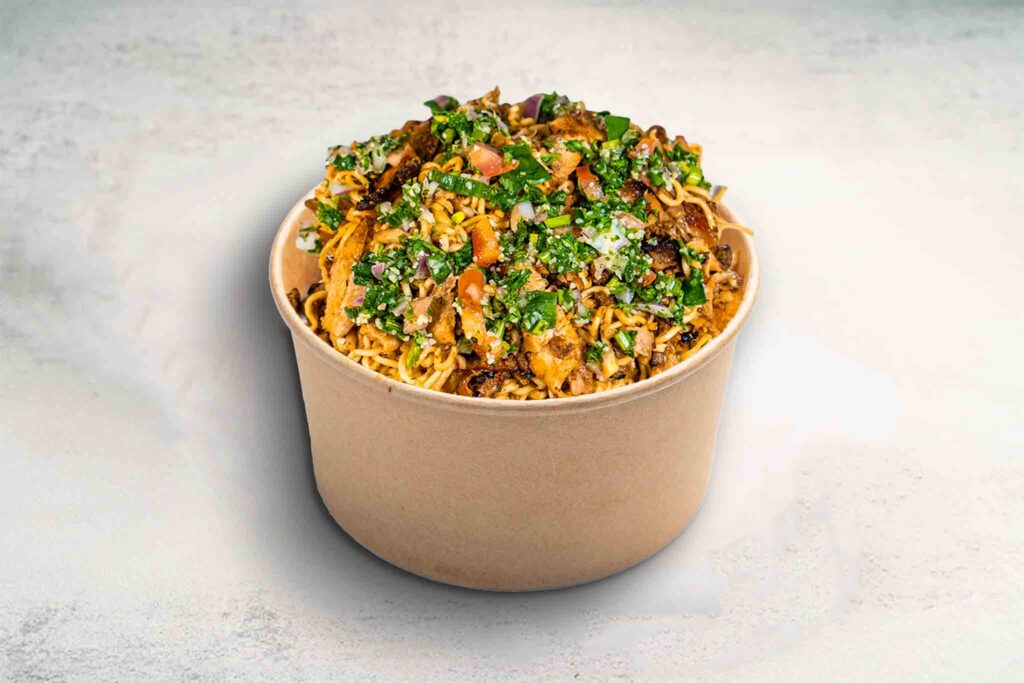Mi Goreng topped with juicy rotisserie chicken and fresh tabouli for a delicious twist on a childhood favorite.